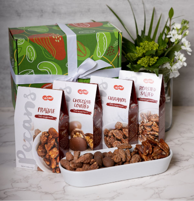 A WataNut Signature Pecan Gift Box including boxes of Praline Pecans, Chocolate Covered Pecans, Cinnamon Pecans and Roasted Salted Pecans. Beautifully displayed in our signature green box with a white ribbon 